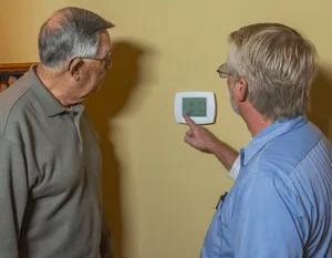 Residential Services — Men Checking the Thermostat in Nashville, TN